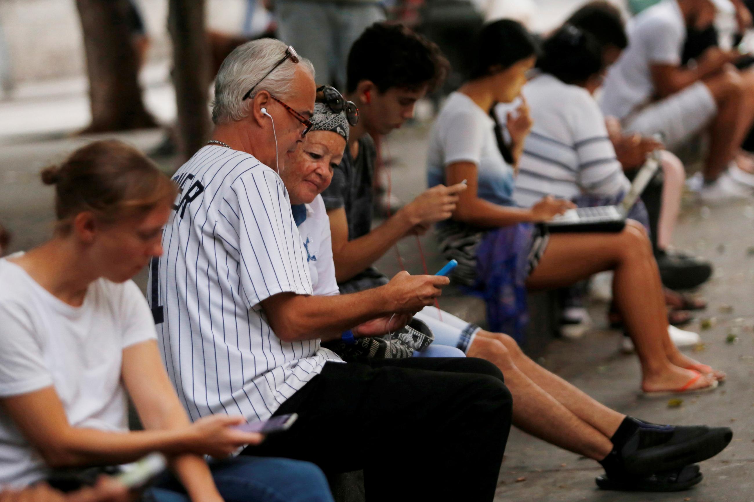 People use the internet at a hotspot, in Havana, Cuba, on December 18, 2018. 