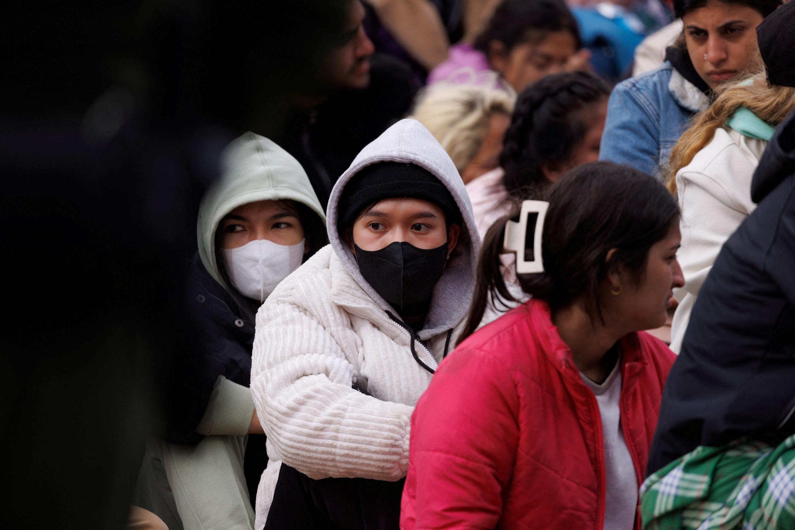 Migrants gather between primary and secondary border fences as the United States prepares to lift COVID-19 era Title 42 restrictions, near San Diego, California, on May 10, 2023. 