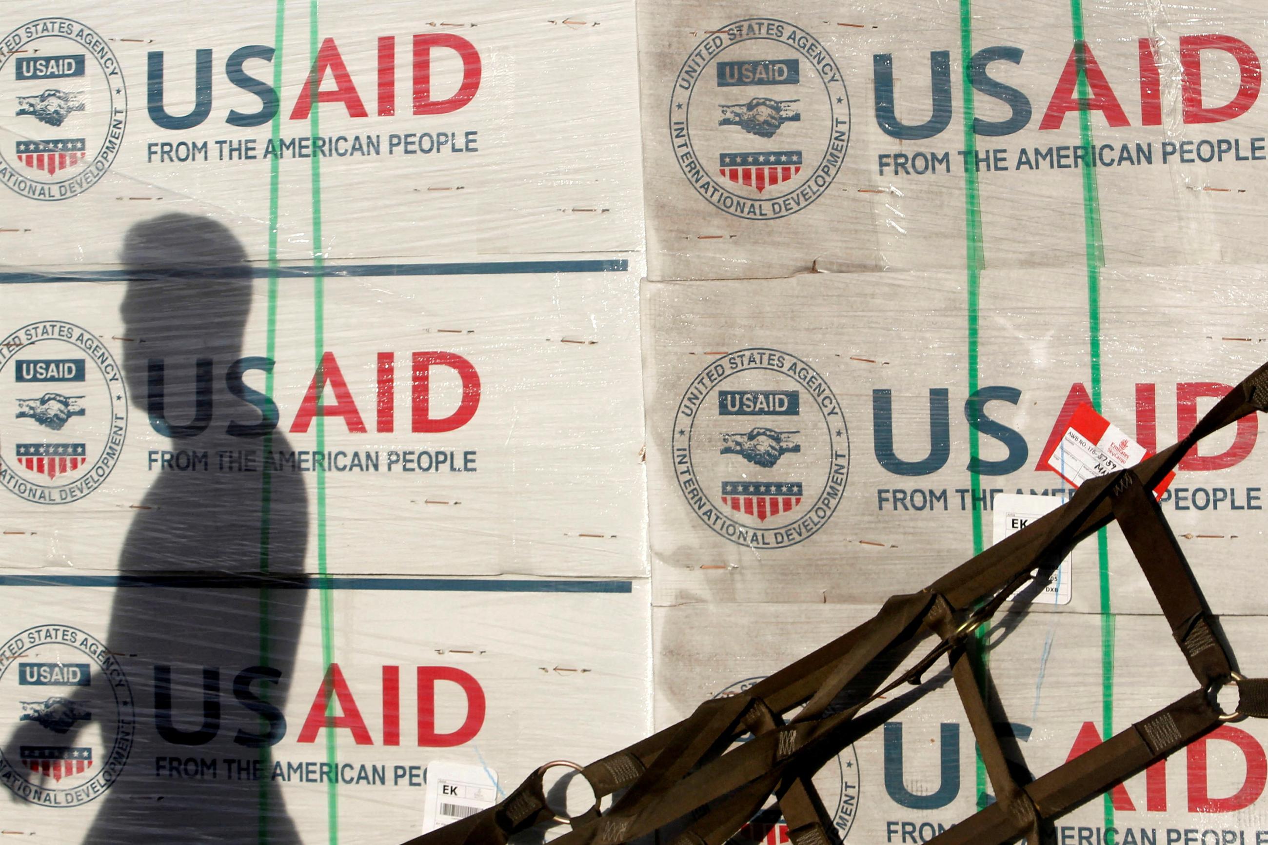 The shadow of a Philippine Army personnel is cast on boxes of relief items from USAID for the victims of super typhoon Haiyan, at Villamor Air Base, in Manila, Philippines, on November 13, 2013. 