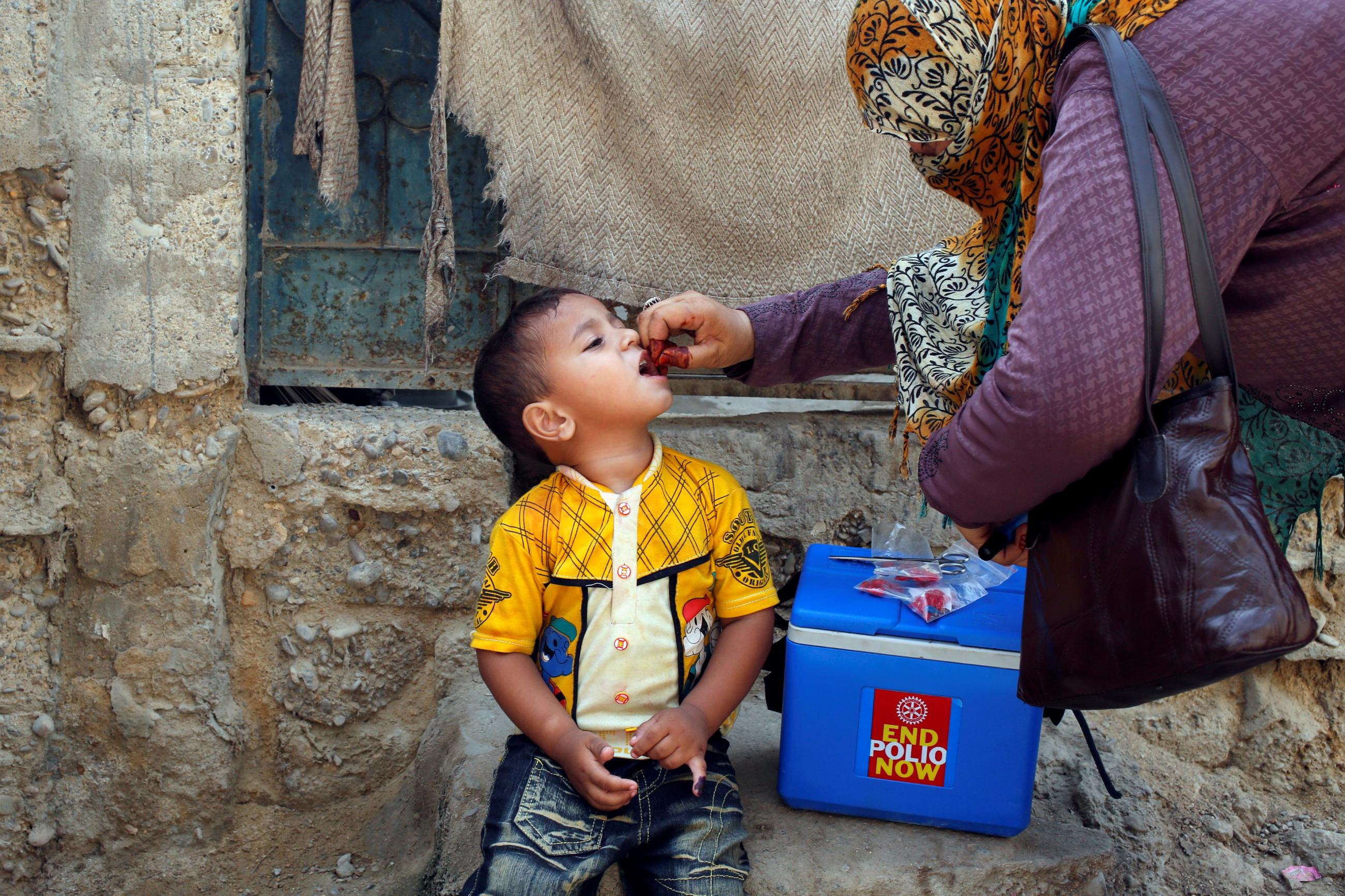 A boy receives polio vaccine drops, during a polio vaccination campaign, in Karachi, Pakistan, on April 9, 2018. 