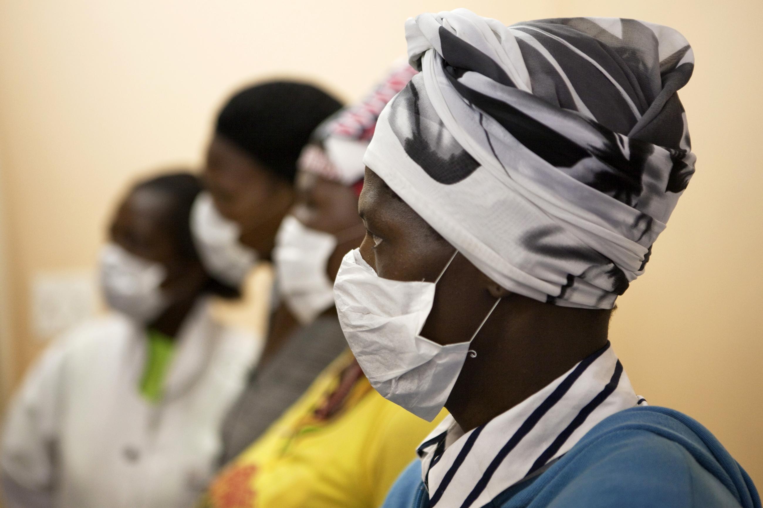 Patients with HIV and tuberculosis (TB) wear masks while awaiting consultation at a clinic in Cape Town, South Africa, on February 23, 2010.