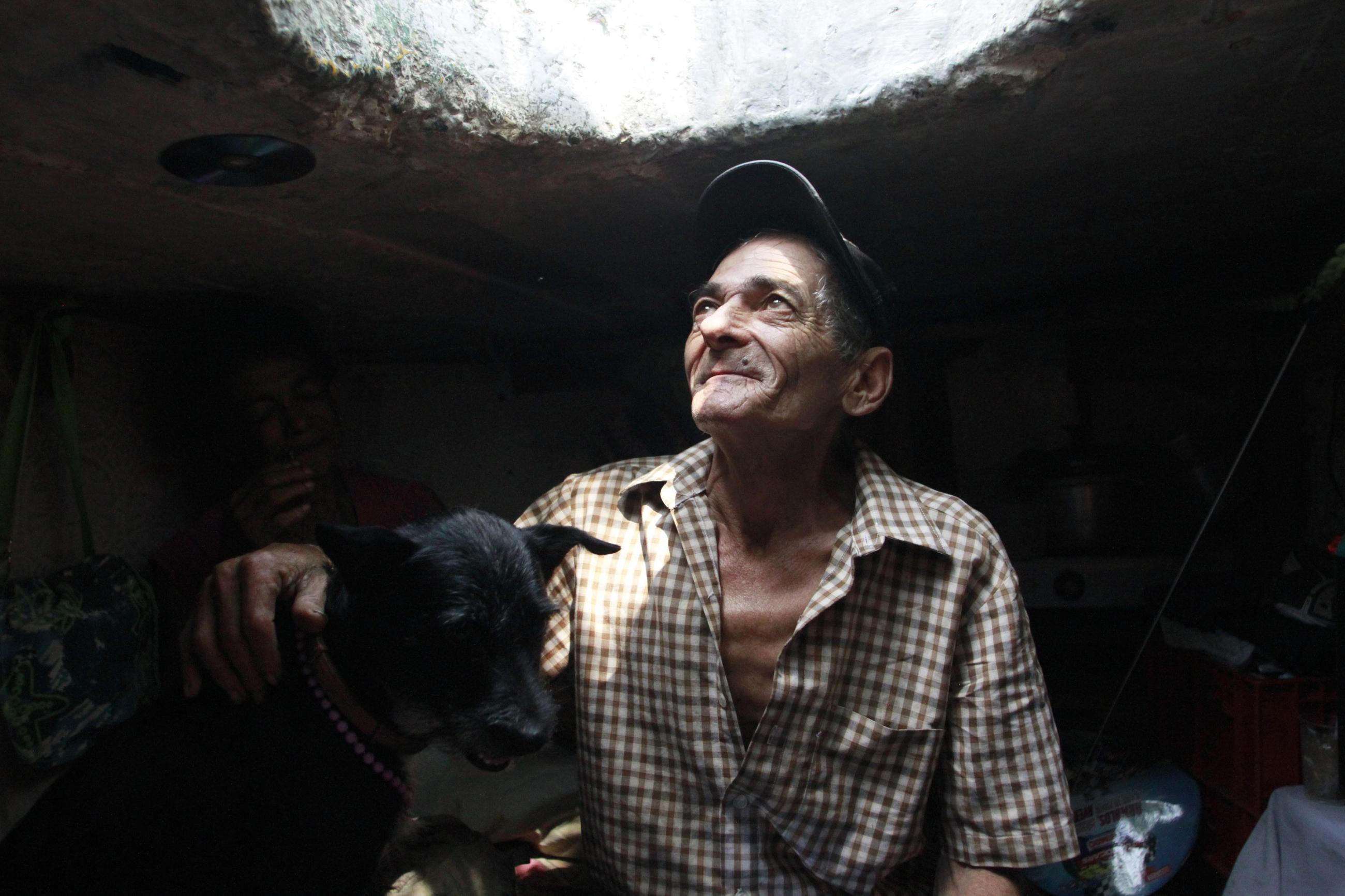 Miguel Restrepo, 62, a former drug addict, looks up from his sewer home in Medellin, Colombia, on December 4, 2012.