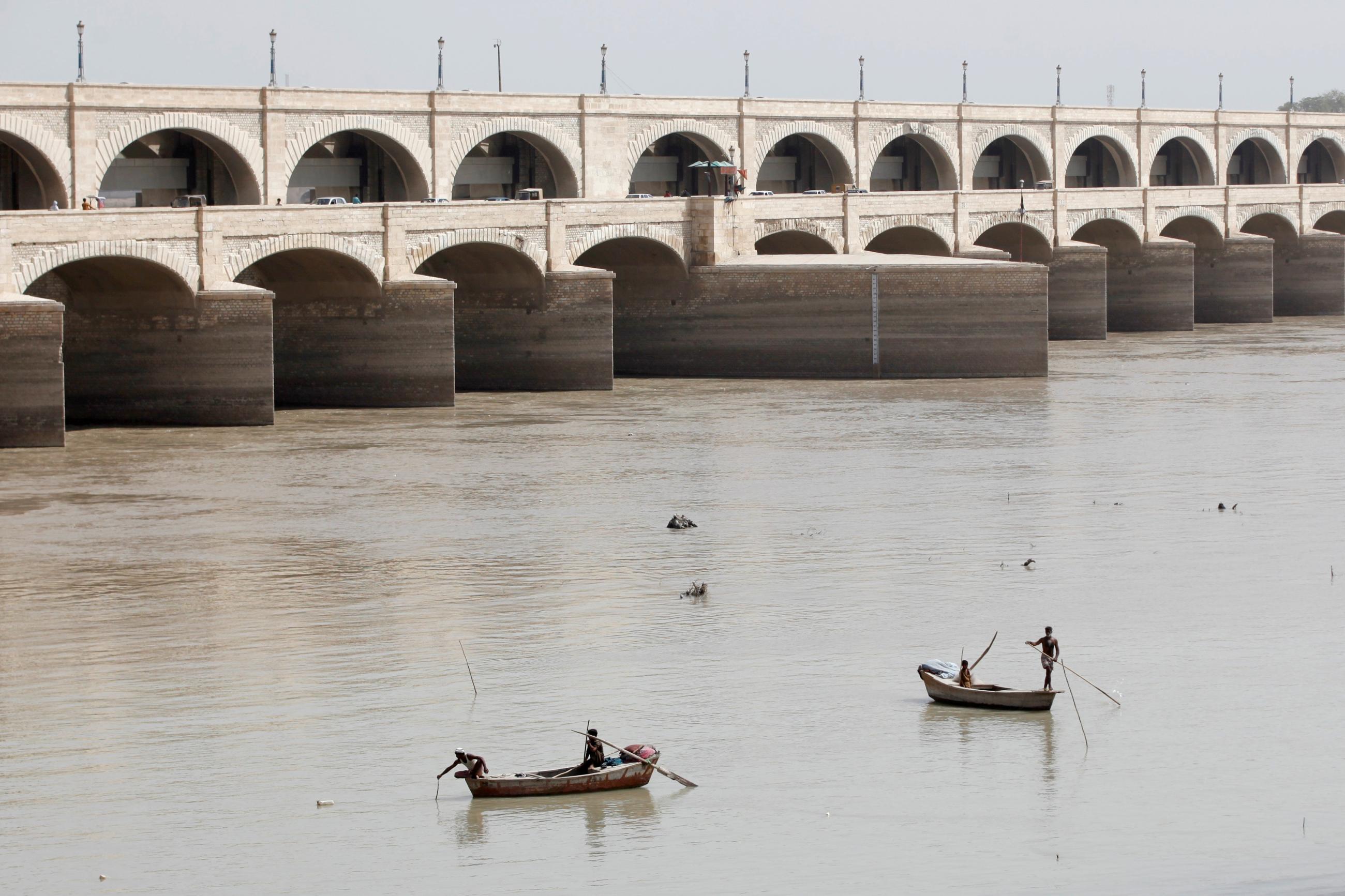Fishermen row their boats as they catch fish on the Indus River, in Sukkur, Pakistan, on March 19, 2017. 