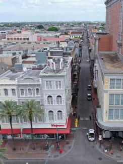 The photo shows a view of the entrance to Bourbon street, which would normally be packed with tourists and other people, almost completely empty. 