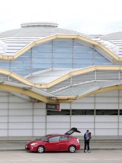 The photo shows the couple embracing on the otherwise empty deck of the airport. 