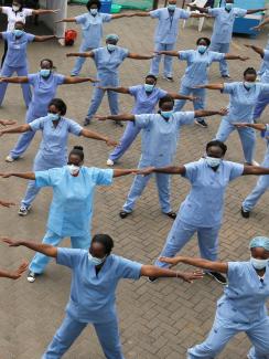 The photo shows a field of nurses exercising in a field.