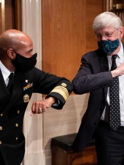 U.S. Surgeon General Jerome Adams and National Institutes of Health (NIH) Director Francis Collins bump elbows after testifying before the Senate Health, Education, Labor and Pensions Committee hearing to discuss about vaccines and protecting public health during the coronavirus disease (COVID-19) pandemic, in Washington, U.S., September 9, 2020.