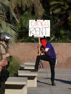 Tenants and housing rights activists protest for a halting of rent payments and mortgage debt as sheriff's deputies block the entrance to the courthouse in Los Angeles, California on October 1, 2020. 