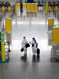 Passengers wearing hazmat suits for protection against the coronavirus disease walk inside the Ninoy Aquino International Airport in Paranaque, Metro Manila, Philippines on January 14, 2021.