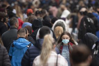 A woman wears a face mask on a busy Queen Street in Cardiff, Wales, United Kingdom on November 21, 2020. 