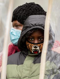 Families gather in "bubbles" during a training session as part of an outreach program to the Black community to increase vaccine trial participation in Rochester, New York on November 14, 2020. 