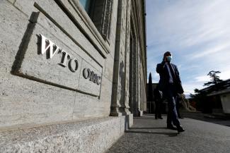 A delegate arrives before a meeting at the World Trade Organization in Geneva, Switzerland on October 28, 2020.