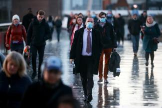 People walk across London Bridge as the spread of the coronavirus disease (COVID-19) continues in London, England on December 15, 2020. 