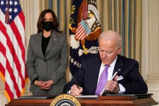 U.S. Vice President Kamala Harris watches as President Joe Biden signs executive orders on his racial equity agenda at the White House in Washington, DC on January 26, 2021.