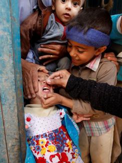 A girl receives polio vaccination drops during a house-to-house vaccination campaign in Yemen's capital Sanaa, April 12, 2016.