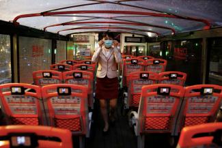 A tour guide adjust her face mask to protect herself from the coronavirus disease (COVID-19) in an empty Taipei Sightseeing bus in Taipei, Taiwan, May 22, 2020.