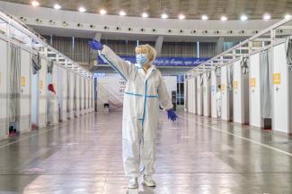 A nurse invites people to the booths to receive AstraZeneca vaccine against the coronavirus disease (COVID-19) in Belgrade, Serbia, March 25, 2021