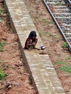 A girl plays with clay next to a railway track in Agartala, India on May 28, 2015.