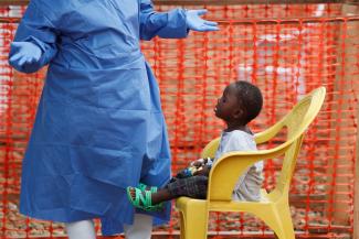 An Ebola survivor plays with a boy suspected of being infected with Ebola virus in a transit centre in Beni, North Kivu Province of Democratic Republic of Congo, December 15, 2018. 