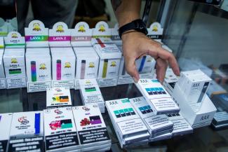 A vape shop worker organizes electronic smoking products in a local store in Jersey City, New Jersey, U.S., September 12, 2019.