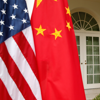 U.S. and Chinese flags stand at attention outside the White House in Washington, DC on September 25, 2015. 