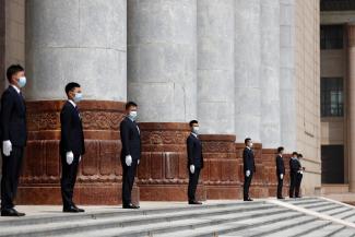 Security personnel wearing face masks following the coronavirus disease (COVID-19) outbreak stand guard outside the Great Hall of the People after the op