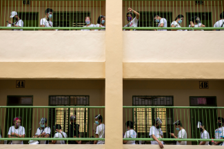 People whose jobs were affected by COVID restrictions wait in lines to receive cash assistance from the government, at an elementary school in Quezon City, Metro Manila, Philippines, April 12, 2021.