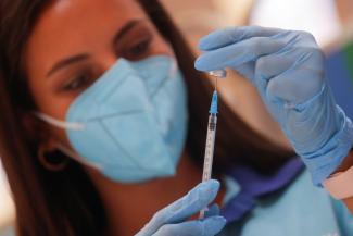 A healthcare worker prepares a dose of the "Comirnaty" Pfizer BioNTech COVID-19 vaccine against the coronavirus disease (COVID-19) at a vaccination centre in Ronda, Spain June 30, 2021.