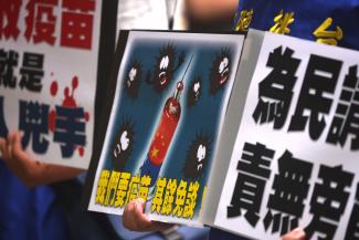 Protesters hold placards reading "We want vaccines, there is nothing more to talk about" in Taipei, Taiwan, on May 24, 2021.