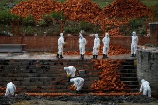 Workers wearing personal protective equipment (PPE) work to extend the crematorium as the number of people who died from coronavirus disease (COVID-19) surges, as India's outbreak spreads across South Asia, in Kathmandu, Nepal May 5, 2021.