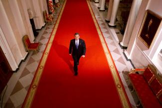 U.S. President George W. Bush walks through the grand foyer on his way to a press conference in the East Room of the White House in Washington October 11, 2001