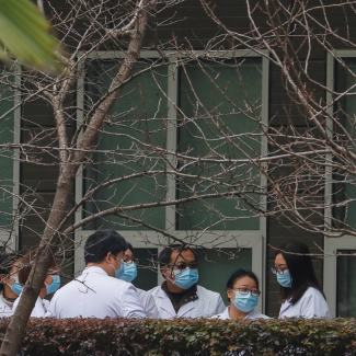 Chinese scientists at Hubei Animal Epidemic Disease Prevention and Control Center during a visit with a WHO team investigating the origins of COVID-19, in Wuhan, China, on February 2, 2021.