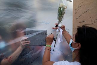 People write notes at the end point of a silent walk organized by Lebanese non-profit organization Embrace, marking World Suicide Prevention Day, in Beirut, Lebanon September 12, 2021.