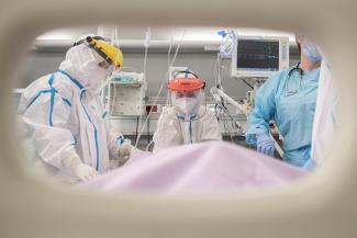 Doctor Tatjana Peric treats a patient suffering from COVID-19 on International Women's Day at the intensive care unit of the Clinical Center of Vojvodina, in Novi Sad, Serbia, March 8, 2021.