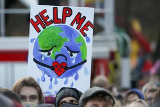 Demonstrators carry a sign as they attend a protest during the UN Climate Change Conference (COP26), in Glasgow, Scotland, on November 6, 2021.