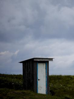 A toilet stands in a field on private property in the town of Yuzhno-Kurilsk on Kunashir Island which is part of the Kuril Islands group in Russia, September 16, 2015.