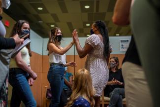 Ava Kreutziger, 14, gives Croix Hill, 15, a high five after Croix received her first COVID vaccine at the Ochsner Center for Primary Care and Wellness, in New Orleans, Louisiana, May 13, 2021.