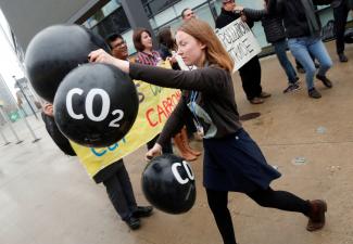 Activists protest against the carbon dioxide emissions trading in front of the World Congress Centre Bonn, the site of the COP23 U.N. Climate Change Conference, in Bonn, Germany, November 17, 2017