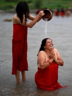 Nepalese women perform a ritual as they take a holy bath in the Manahara River during the Rishi Panchami festival in Kathmandu, Nepal, September 3, 2019. 