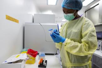 , a laboratory technician, writes on a GeneXpert Xpress SARS-CoV-2 coronavirus disease (COVID-19) testing cartridge in the National Institute for Biomedical Research laboratory (INRB) in Goma, Democratic Republic of Congo February 6, 2021. Picture taken February 6, 2021