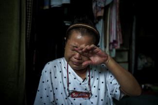 who survived after she tried to take her own life in April outside Thailand's finance ministry building, during the coronavirus disease (COVID-19) outbreak, cries during an interview with Reuters, at her home in Samut Sakhon province, Thailand, May 29, 2020. 