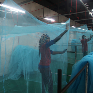 Workers look for holes in mosquito netting at the A to Z Textile Mills factory where insecticide-treated bed nets are produced, in Arusha, Tanzania, on May 10, 2016. REUTERS/Katy Migiro