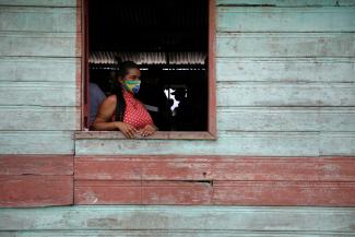 An indigenous woman waits to receive Sinovac's COVID-19 vaccine in the village of São José, which is situated along the Urubu River in the state of Amazonas, Brazil, on February 13, 2021. 