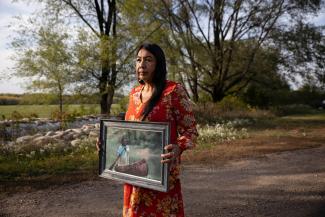 Carrie Owen, Art Owen's wife, holds a portrait of him after he passed away due to a diabetes-related heart attack, in Red Wing, Minnesota, U.S., September 29, 2021.