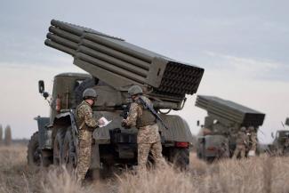 Service members of the Ukrainian Armed Forces gather near BM-21 "Grad" multiple rocket launchers during tactical military exercises at a shooting range in the Kherson region, Ukraine, January 19, 2022. 