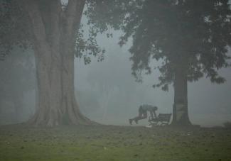 A man exercises in a park on a smoggy morning in New Delhi, India, on November 9, 2017. 