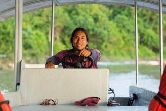 Luciano Peas, a member of the Achuar Indigenous community in Ecuador, captains a solar-powered boat.