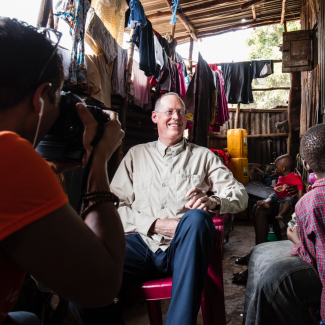 Paul Farmer visits Ebola survivor Yabom Koroma and her family at their home in the Mountain Court section of Freetown, Sierra Leone on December 14, 2015. Photo courtesy of PIH.