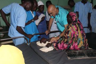 Dr. Tom Catena tends to a patient, at Mother of Mercy hospital, in Sudan.