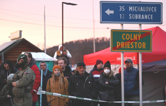People wait at the Ukrainian border in Vysne Nemecke, Slovakia after Russia launched a massive military operation against Ukraine